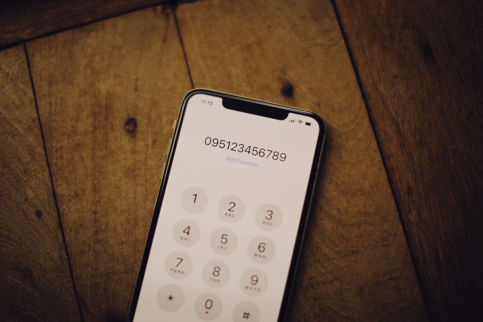 Person dialing a phone to call for a free foundation repair estimate